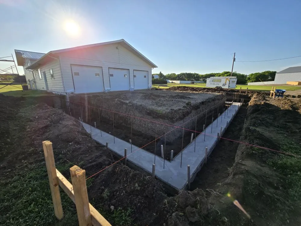 Footings set and ready for the Tappen addition — original 1988 structure on the left.